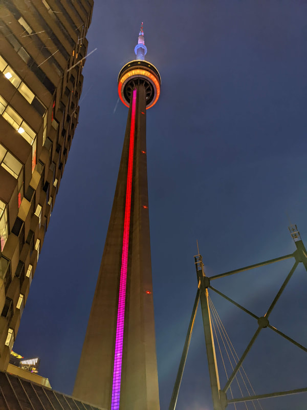 CN Tower lit from below in rainbow colors for Pride Month.